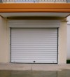 Garage aluminum door with automating mechanism for a house in Kos