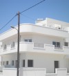 Two storey house with white shutters