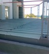 Metallic support for raised floor in a hotel complex